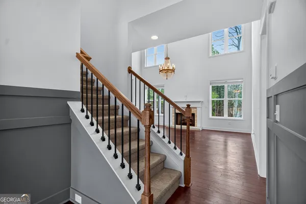 a bathroom with a granite countertop double vanity sink a mirror and shower