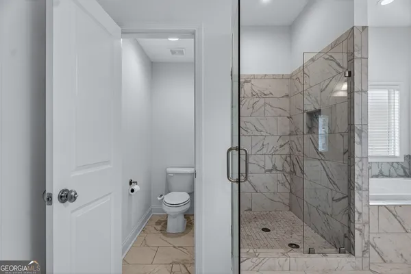 a view of an empty room with a ceiling fan and a window