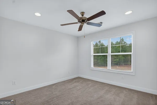 a view of room with furniture and a ceiling fan