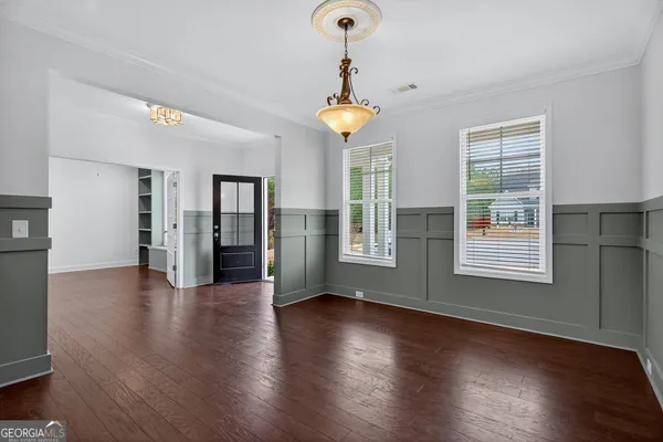a view of wooden floor and windows in a room
