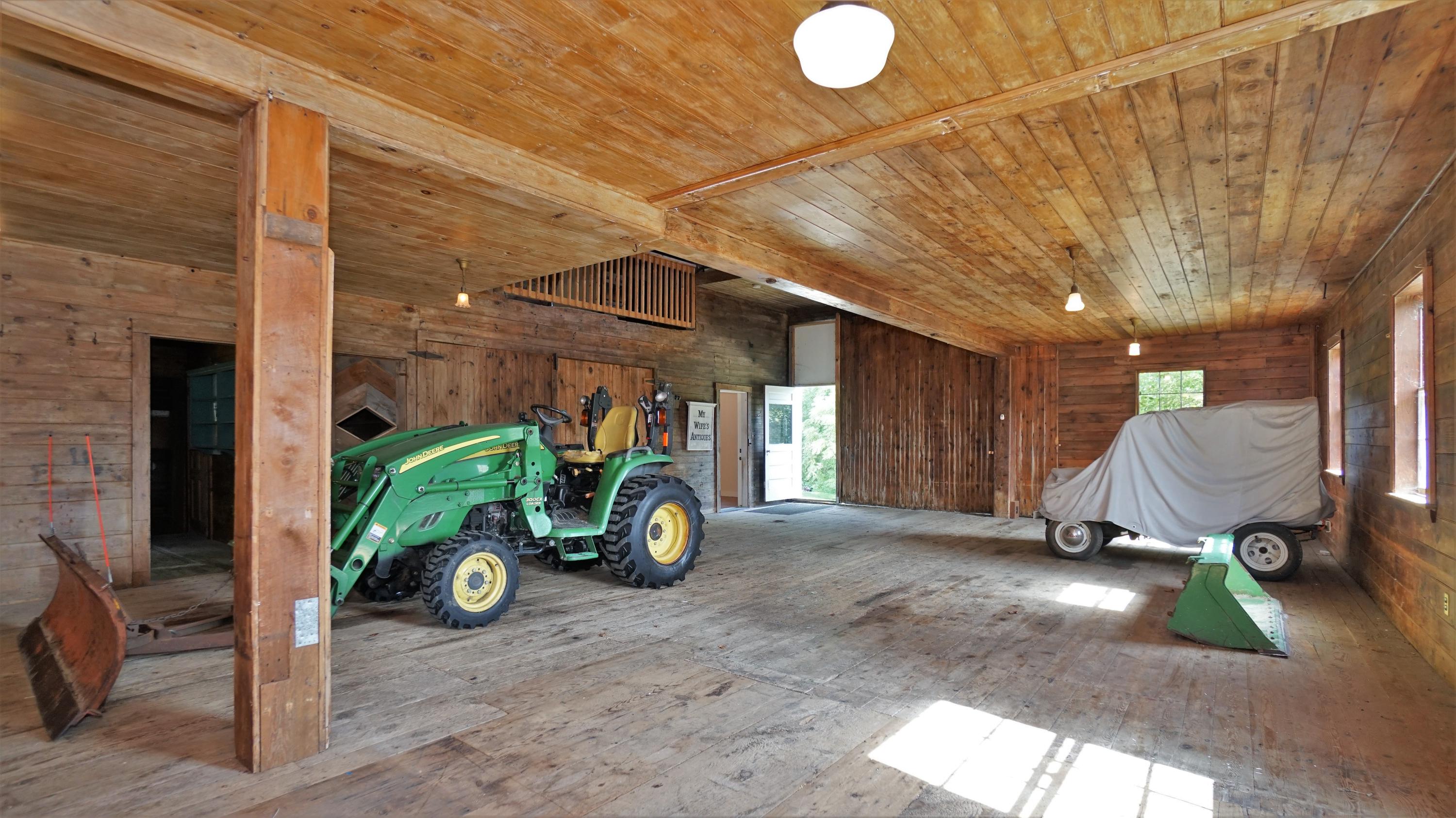 337 Intervale Road New Gloucester, ME 04260 - Photo 60 of 86 First floor of barn with tractor