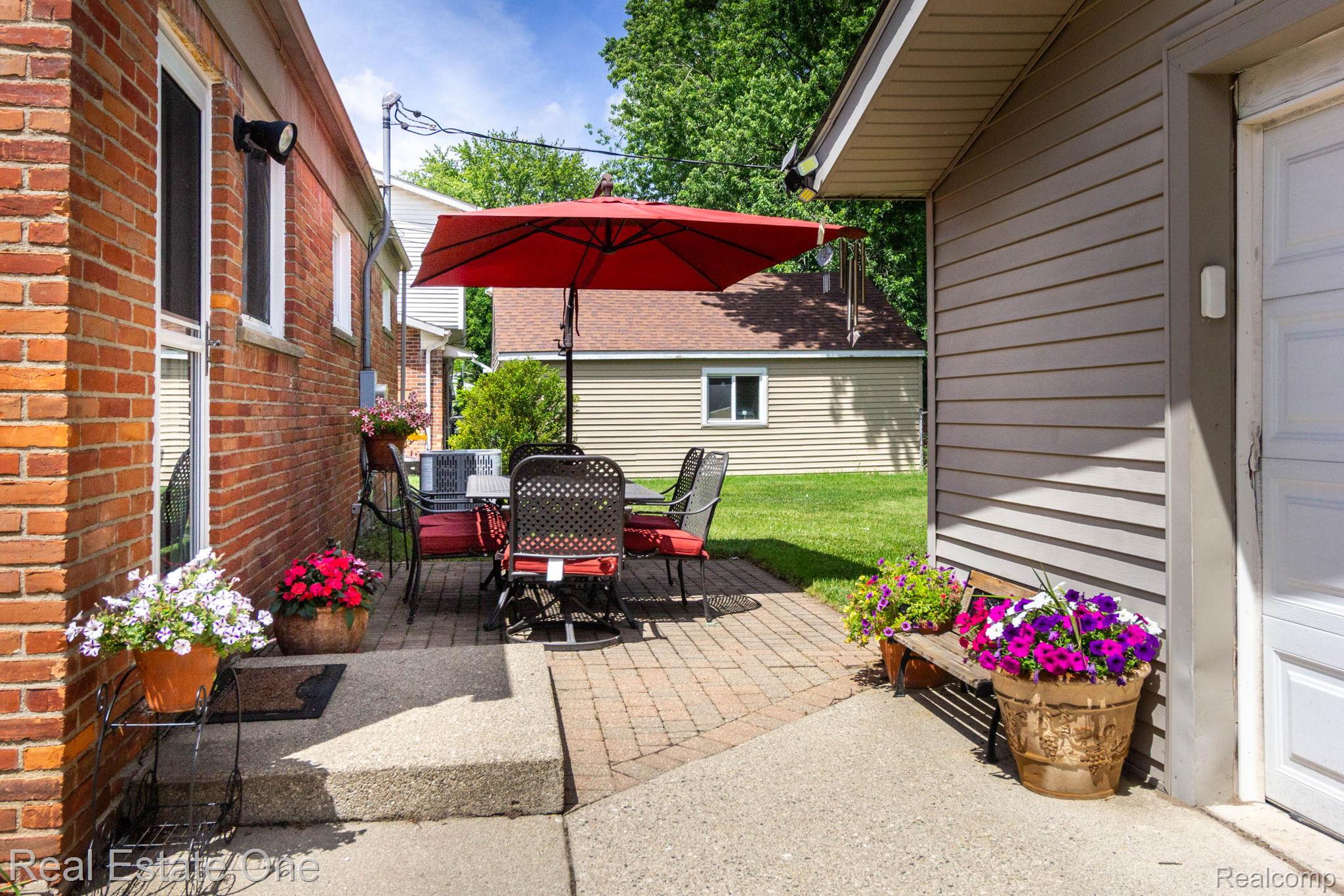 220 Winry Drive Rochester, MI 48307 - Photo 26 of 35 Brick exterior featuring a paver patio area