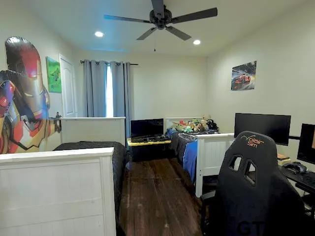 a utility room with wooden floor washer and dryer
