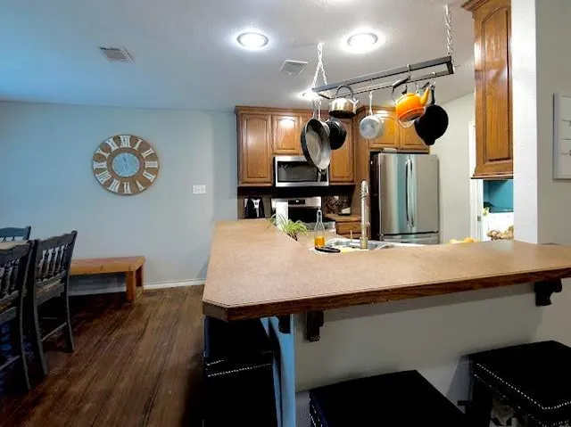 a kitchen with a sink cabinets and stainless steel appliances