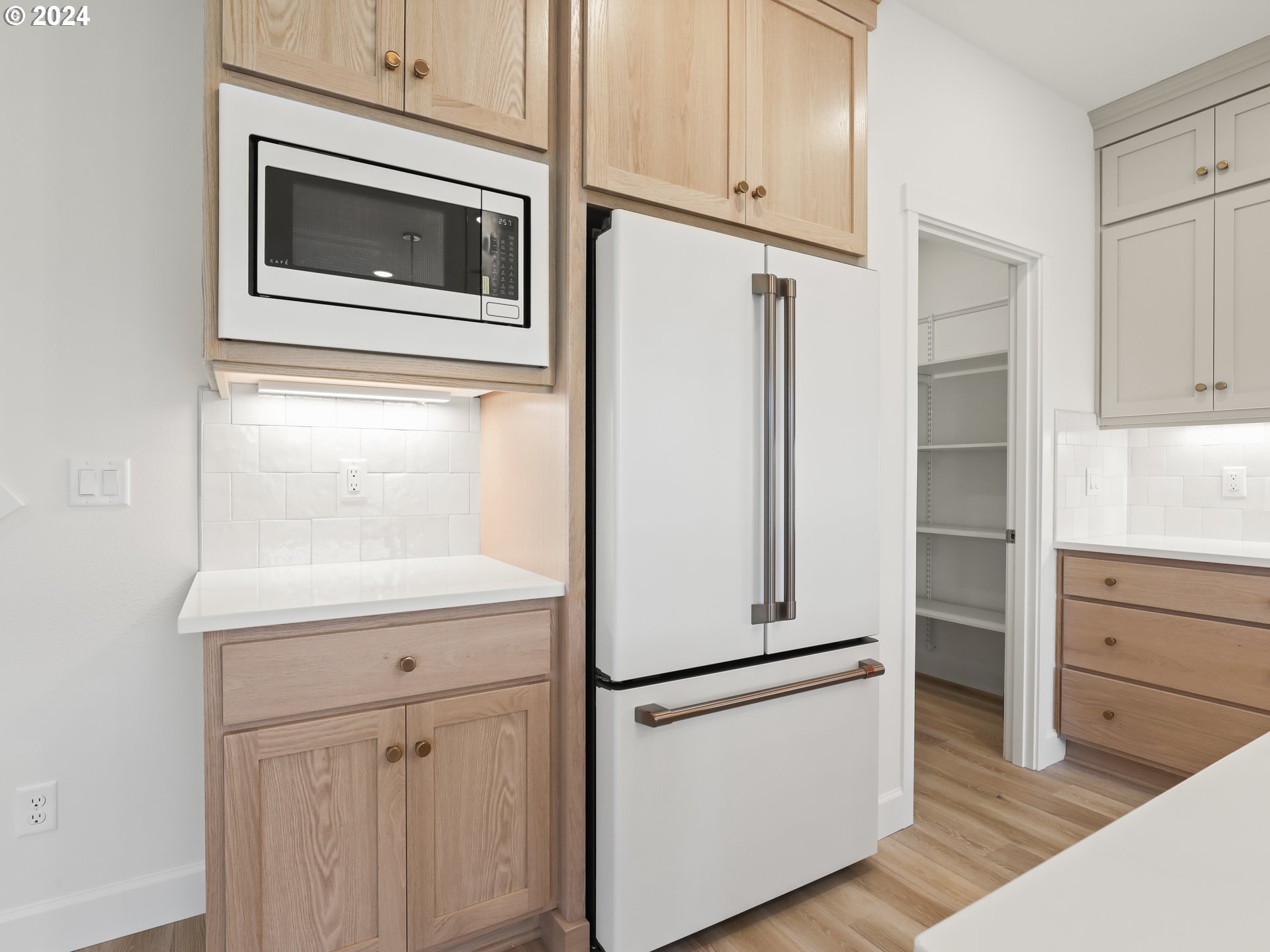 4400 North 12th Way Ridgefield, WA 98642 - Photo 12 of 31 a kitchen with white cabinets and white appliances