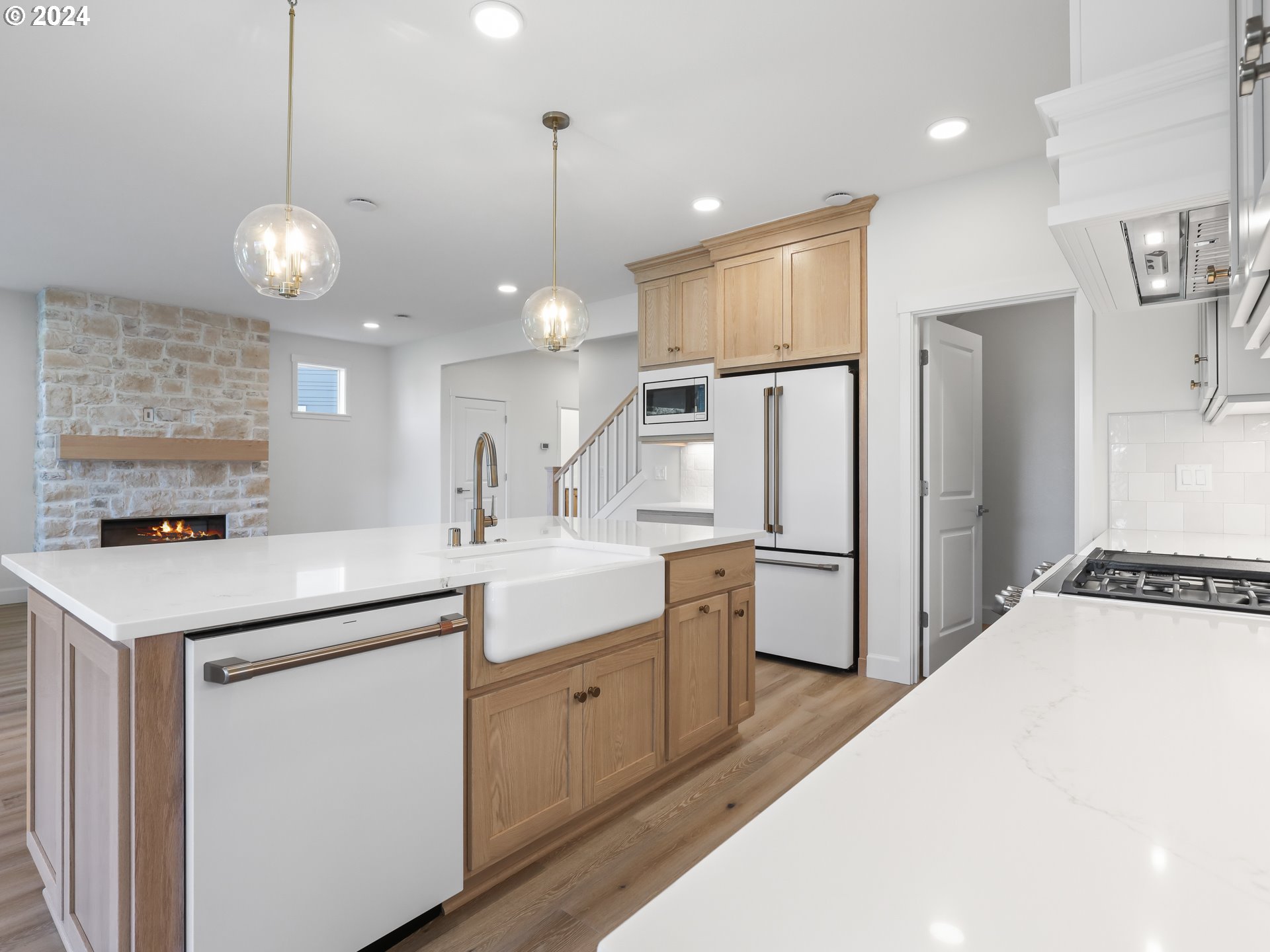 4400 North 12th Way Ridgefield, WA 98642 - Photo 13 of 31 a kitchen with a white center island a sink stainless steel appliances and cabinets