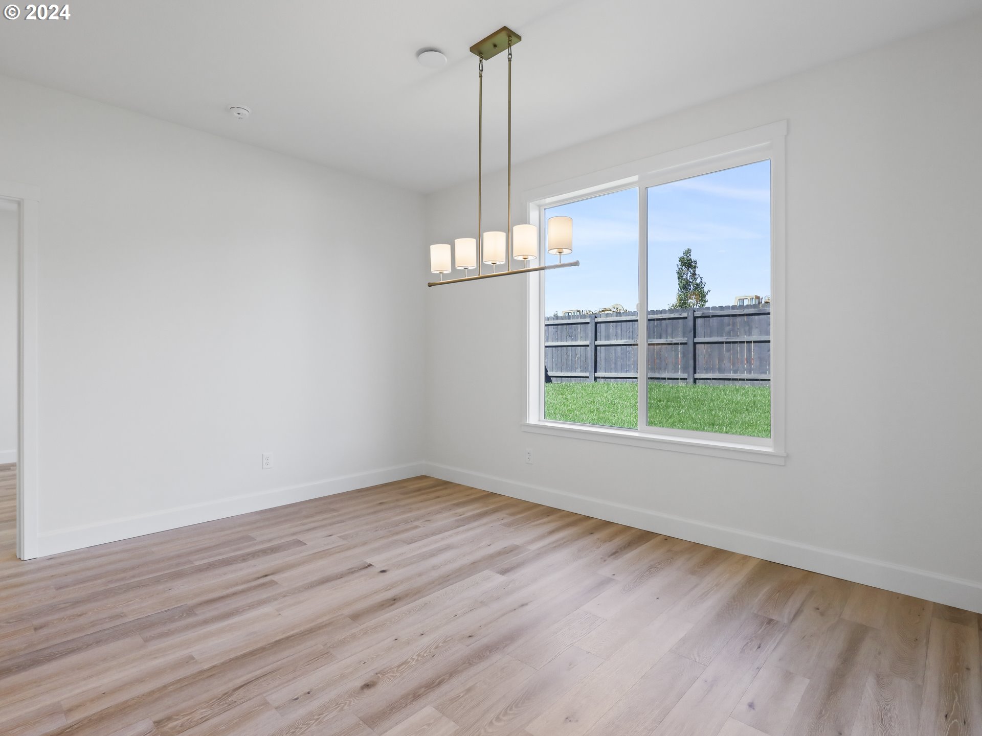 4400 North 12th Way Ridgefield, WA 98642 - Photo 16 of 31 a view of empty room with wooden floor and fan