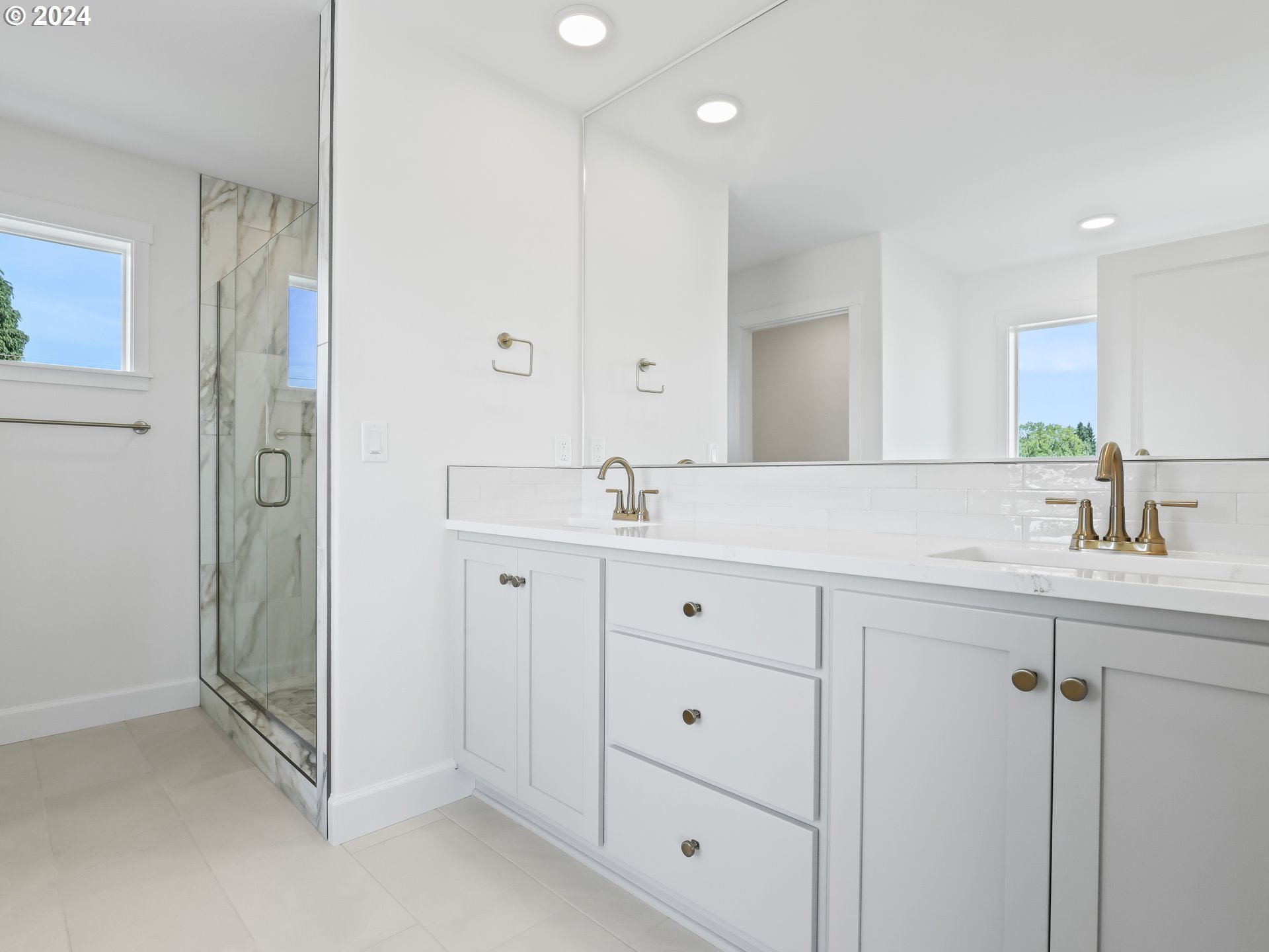 4400 North 12th Way Ridgefield, WA 98642 - Photo 26 of 31 a bathroom with double sink and a mirror