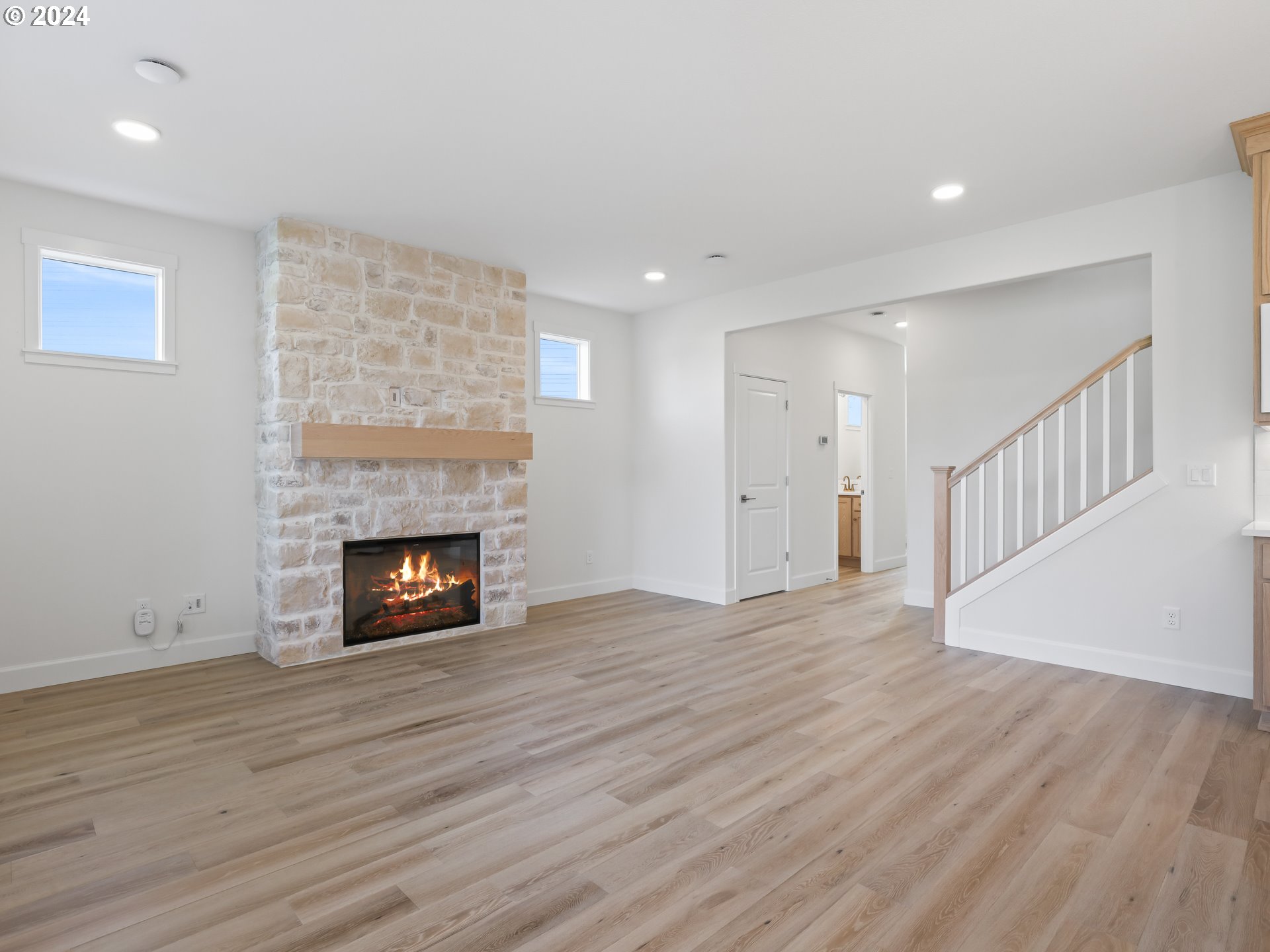 4400 North 12th Way Ridgefield, WA 98642 - Photo 9 of 31 a view of an empty room with wooden floor fireplace and a window