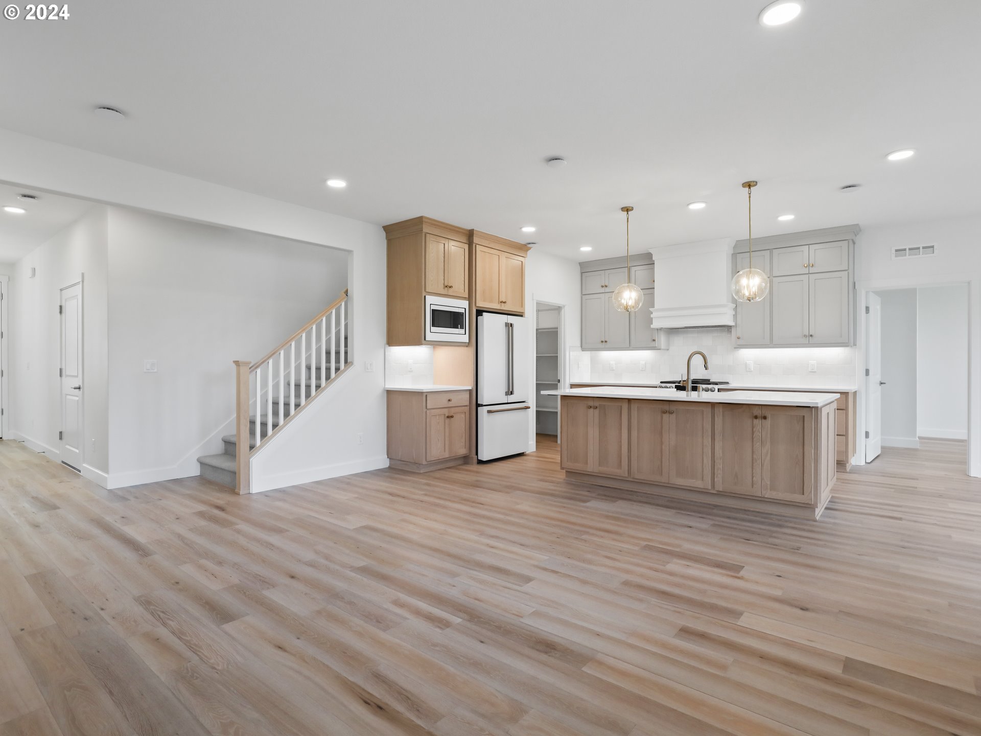 4400 North 12th Way Ridgefield, WA 98642 - Photo 10 of 31 a view of kitchen with kitchen island white cabinets and white appliances