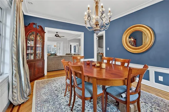 a view of a dining room with furniture and a chandelier