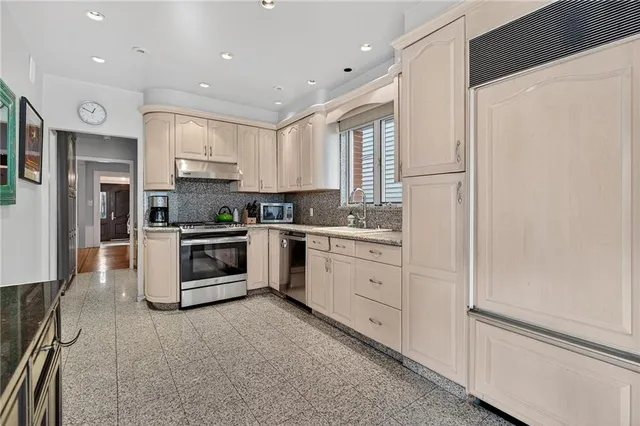 a kitchen with a sink stove and cabinets