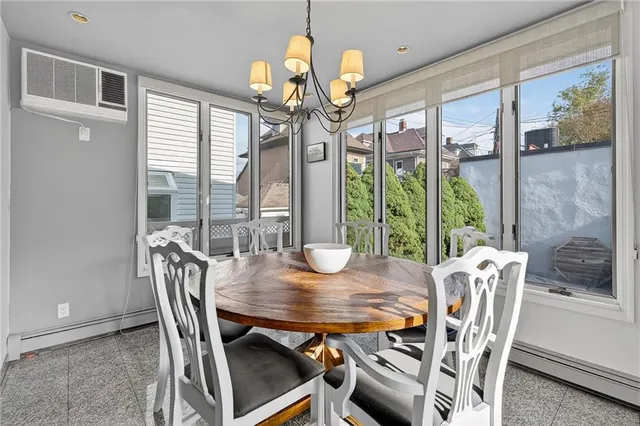 a view of a dining room with furniture a chandelier and wooden floor