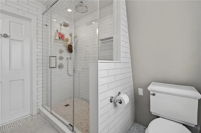 a spacious bedroom with a bed and a chandelier