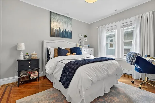 a spacious bedroom with a bed and a chandelier
