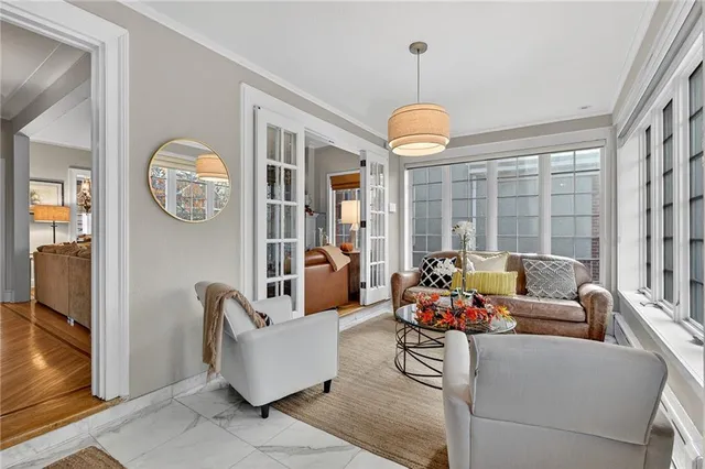 a living room with furniture and floor to ceiling windows