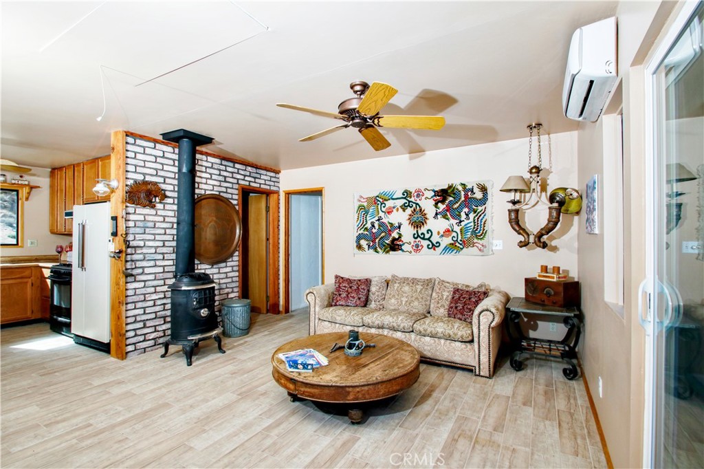 4650 Sizer Canyon Road Johnson Valley, CA 92285 - Photo 11 of 36 a living room with furniture and a fireplace