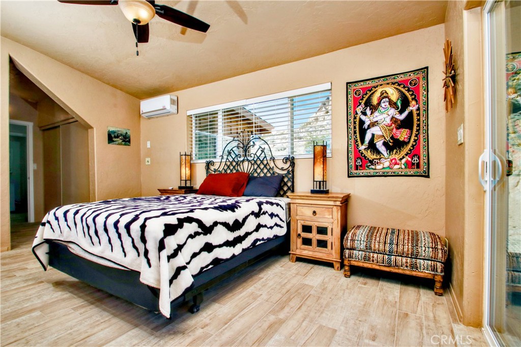 4650 Sizer Canyon Road Johnson Valley, CA 92285 - Photo 18 of 36 a bedroom with a bed and a painting on the wall