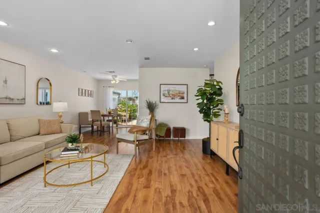 a living room with furniture floor to ceiling window and potted plant