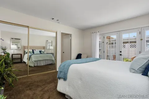 a bedroom with a bed and a large mirror