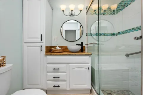 a bathroom with a sink mirror and vanity
