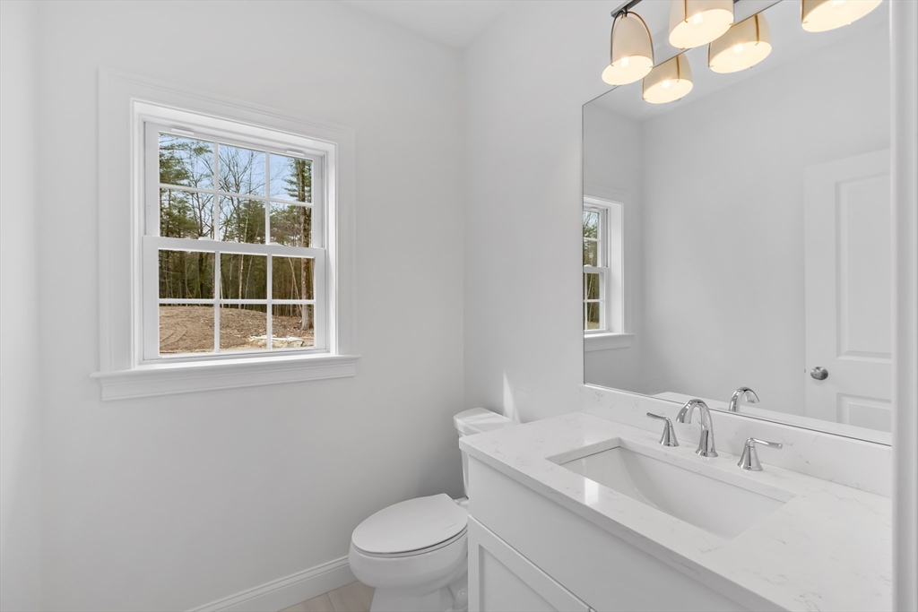 20 Rawson Farm Road Mendon, MA 01756 - Photo 15 of 35 a bathroom with a toilet a sink a mirror and a window