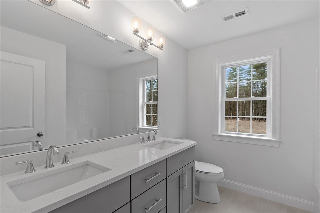 20 Rawson Farm Road Mendon, MA 01756 - Photo 33 of 35 a bathroom with a double vanity sink a toilet and a mirror