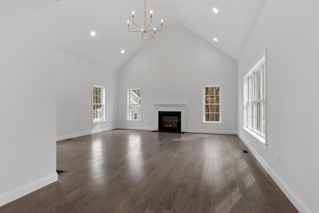 20 Rawson Farm Road Mendon, MA 01756 - Photo 7 of 35 an empty room with wooden floor and fireplace