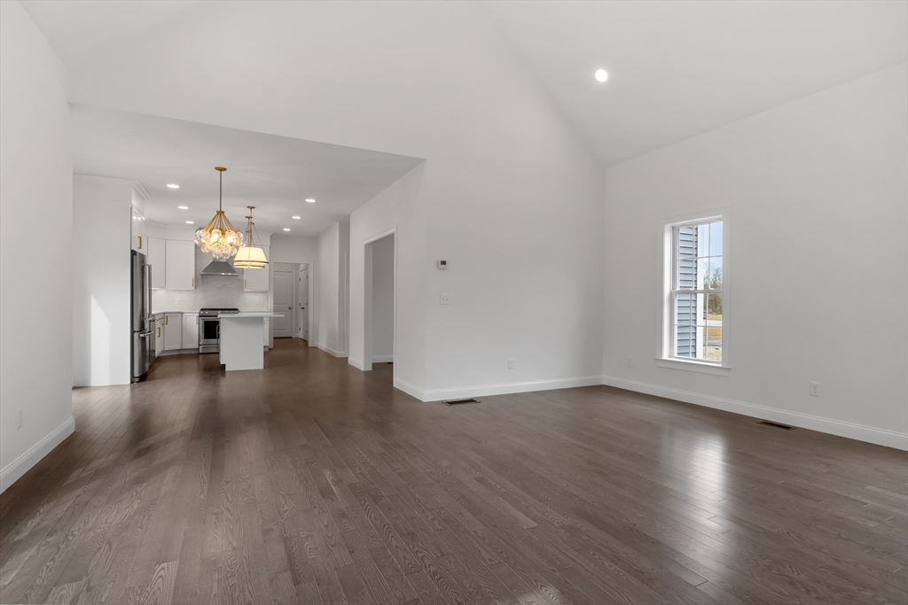 20 Rawson Farm Road Mendon, MA 01756 - Photo 9 of 35 a view of an empty room with wooden floor and a kitchen