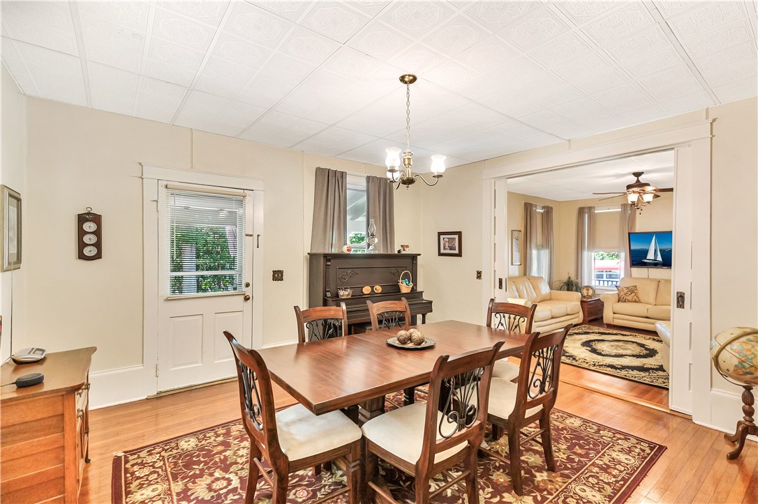 205 West Mauldin Street Walhalla, SC 29691 - Photo 9 of 43 Hardwood flooring and rich wood accents distinguish this inviting dining room, flowing into an adjacent living area and access to the wrap around porch.
