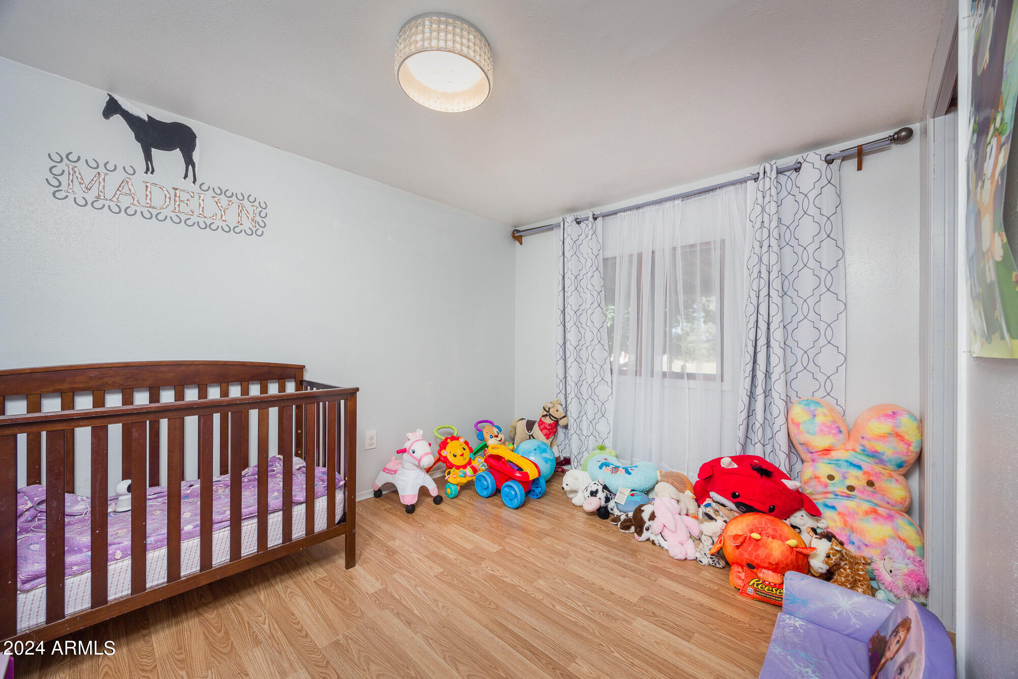 2980 West Williams Road Benson, AZ 85602 - Photo 12 of 32 a bedroom with a bed and a couch