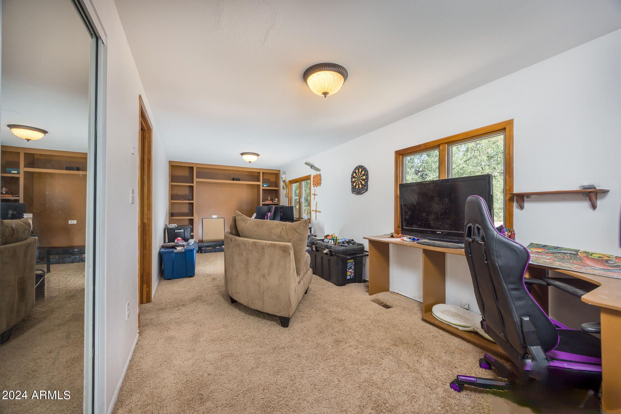 2980 West Williams Road Benson, AZ 85602 - Photo 14 of 32 a view of a livingroom with workspace and a window
