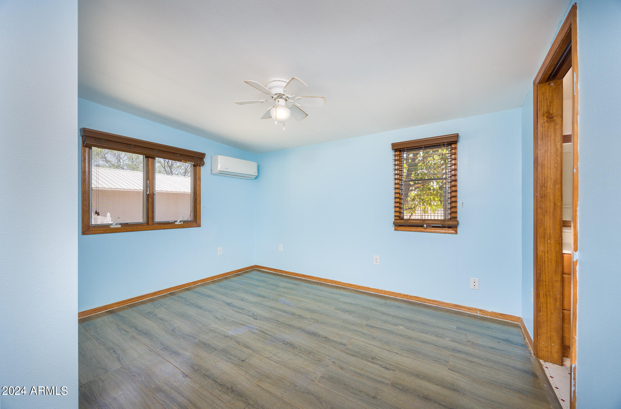 2980 West Williams Road Benson, AZ 85602 - Photo 15 of 32 a view of empty room with wooden floor and fan