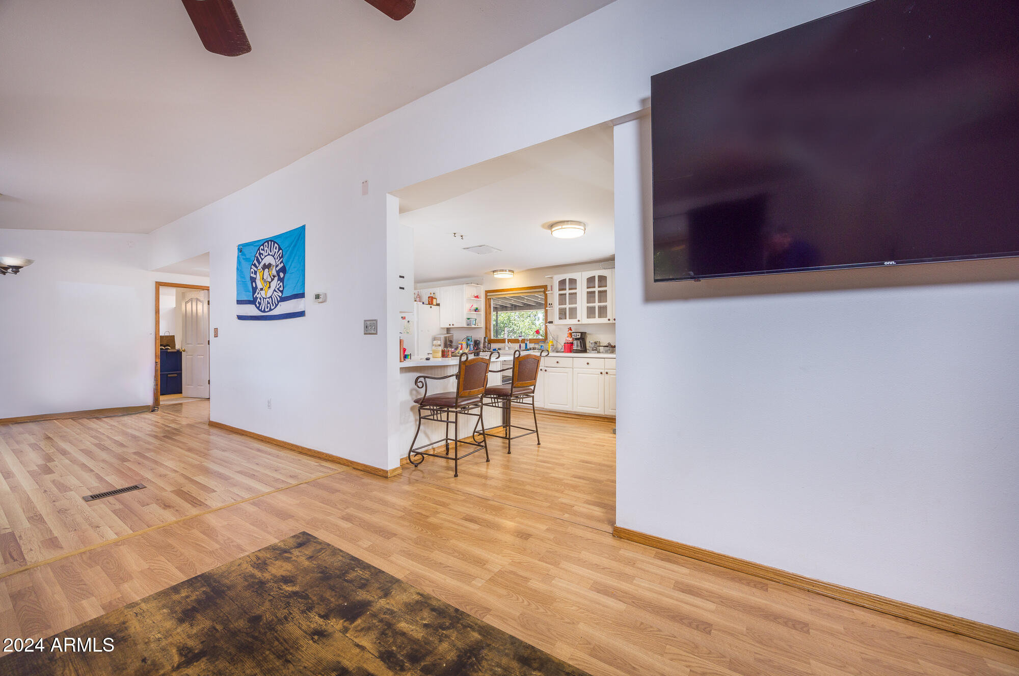 2980 West Williams Road Benson, AZ 85602 - Photo 5 of 32 a view of a livingroom with furniture and a kitchen