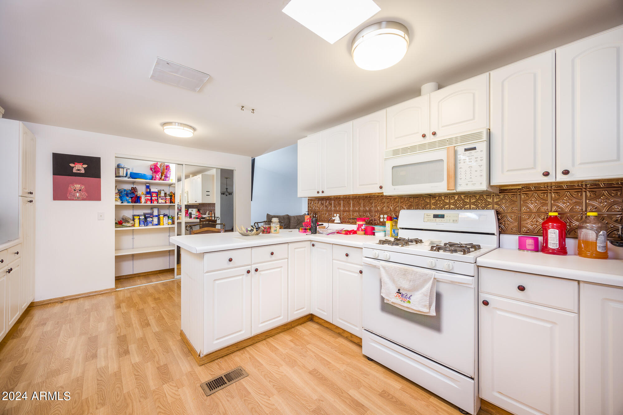 2980 West Williams Road Benson, AZ 85602 - Photo 8 of 32 a kitchen with cabinets a sink and white appliances