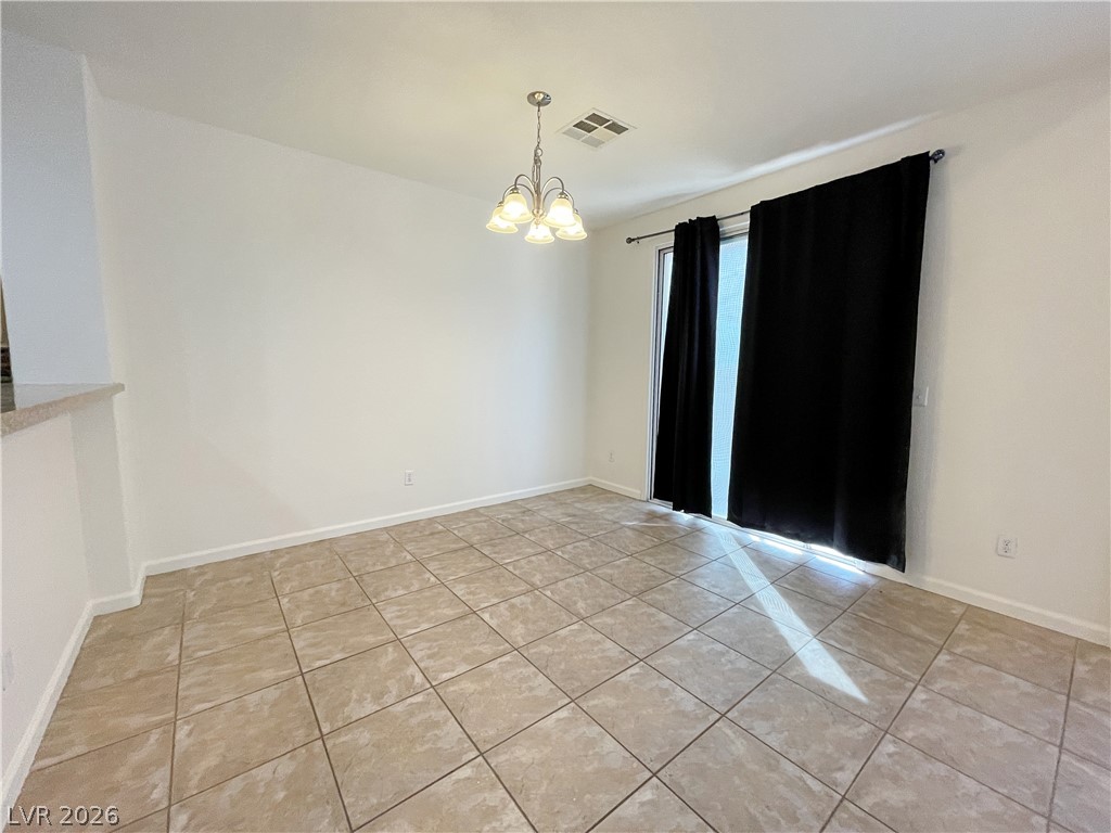 691 Principle Point Avenue Henderson, NV 89012 - Photo 13 of 30 A well-lit area featuring tile flooring and convenient sliding doors leading outside.