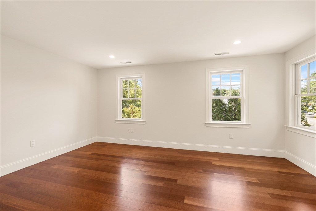 245 East Street Lexington, MA 02420 - Photo 27 of 42 an empty room with wooden floor and window