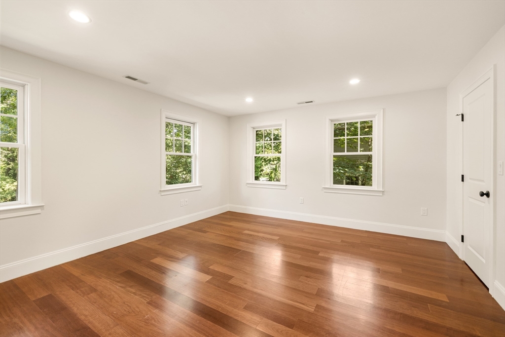 245 East Street Lexington, MA 02420 - Photo 28 of 42 an empty room with wooden floor and windows