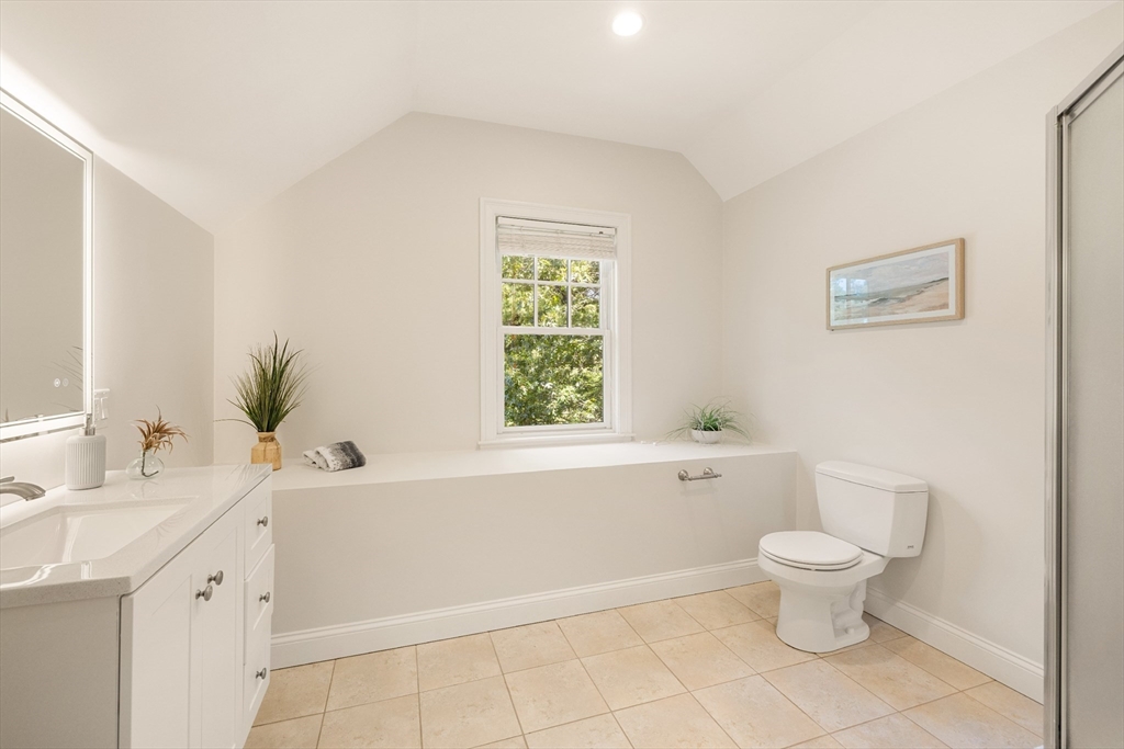 245 East Street Lexington, MA 02420 - Photo 29 of 42 a bathroom with a sink toilet vanity and tub