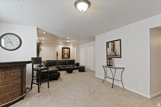 1924 North 2000th Street East Layton, UT 84040 - Photo 26 of 41 Living area with light colored carpet, a textured ceiling, and recessed lighting