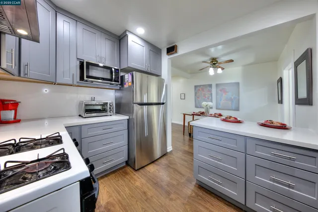 a kitchen with refrigerator and cabinets