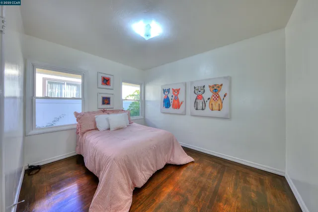 a bedroom with a bed and a painting on the wall