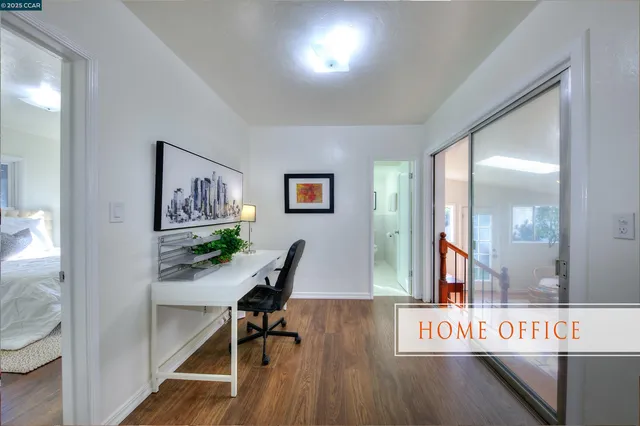 a view of a hallway with wooden floor and furniture