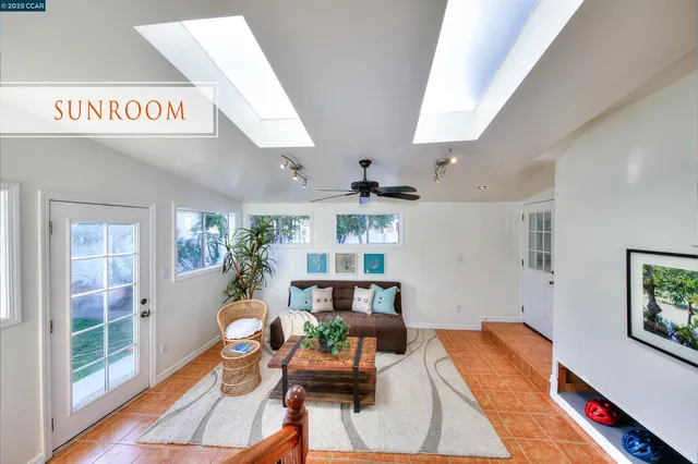a living room with furniture and a book shelf