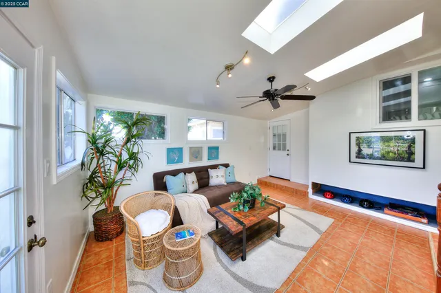a living room with furniture and a potted plant