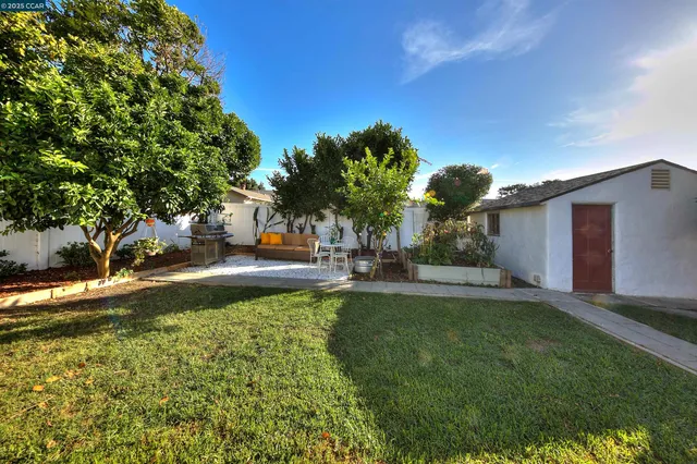 a view of a house with swimming pool and sitting area