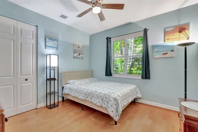 an aerial view of residential houses with outdoor space and trees
