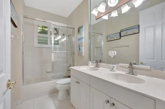 an aerial view of residential houses with outdoor space and street view