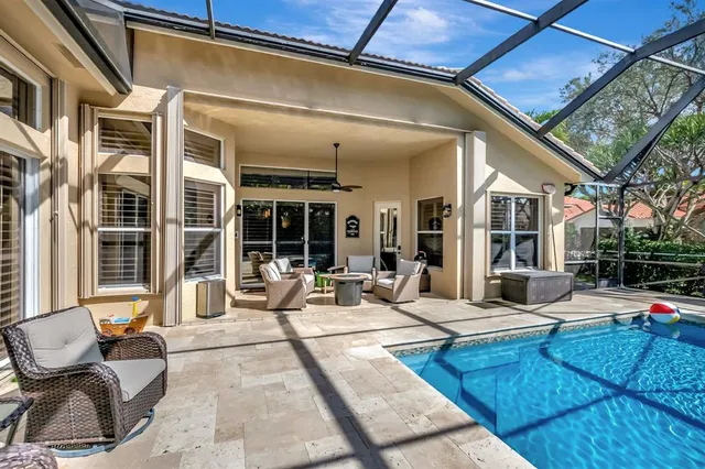 an aerial view of residential house with outdoor space and swimming pool