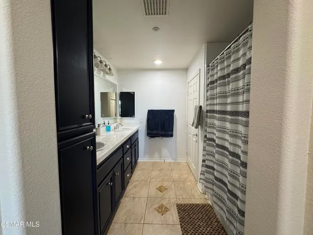 a bathroom with a sink double vanity and a mirror